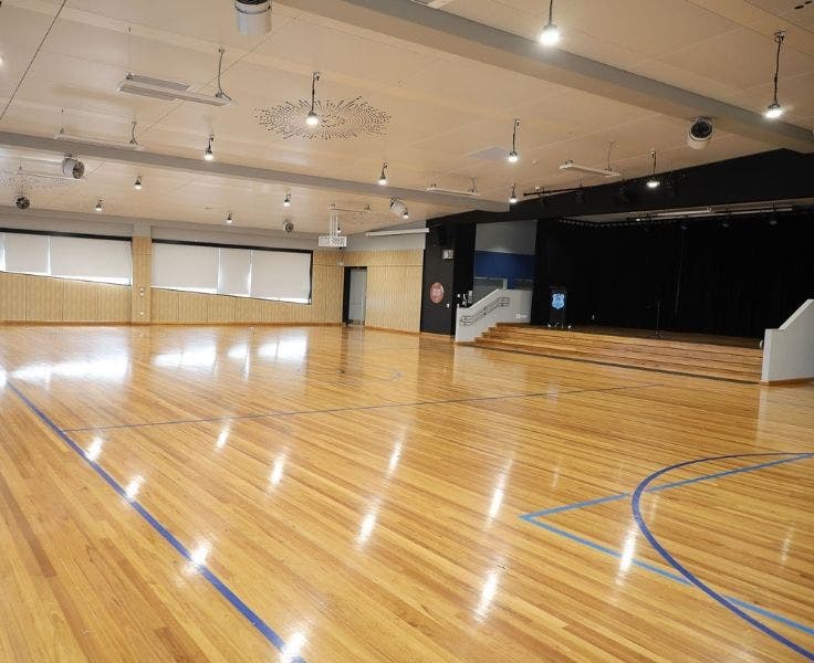 School hall with basketball markings and performance stage