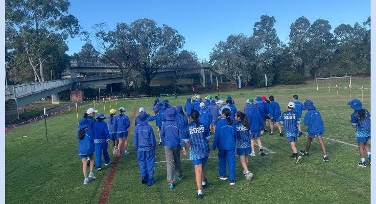 Students lining up to begin cross country race on a oval