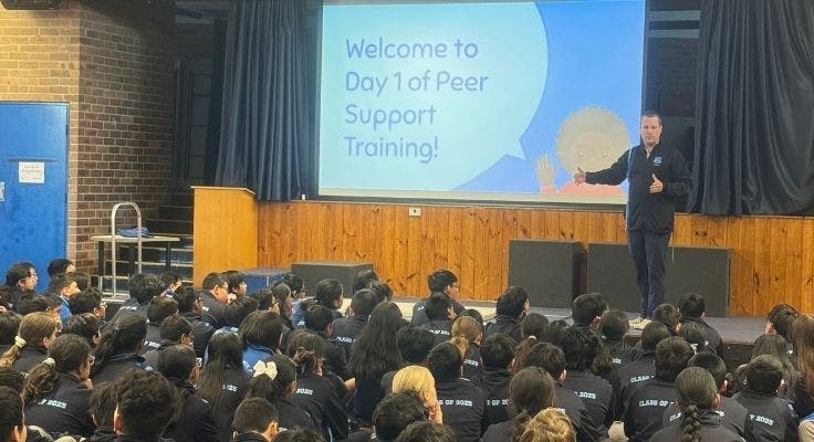 Teacher addressing Year 6 students in front of slide sayifn Welcome to Day 1 of Peer Support Training