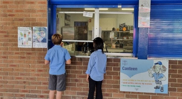 Students standing at canteen window
