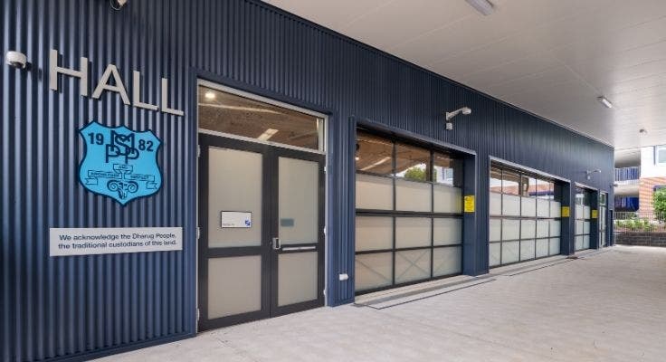 School hall entrance with school crest and doors